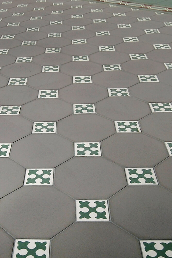 Achteckfliesen in grau mit farbigen Mosaik-Einlegern in grüne Lilie auf weissem Grund und weiss